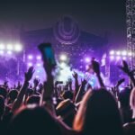 group of people raising there hands in concert